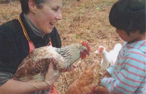 Carolyn Lunt with child and chicken